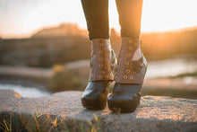 Distressed brown leather short spats with brass grommets