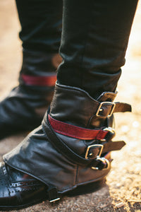 Black leather slouchy spats with buckles and straps